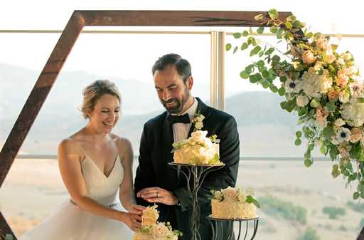 Newly married couple cutting cake at their Jamul Casino Resort wedding at The Rooftop.